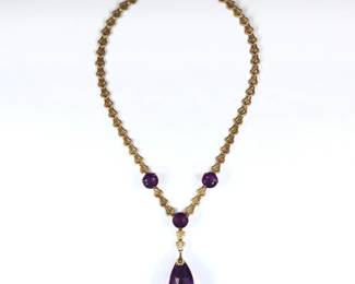 A turn of the century 14k Gold filigree and Amethyst pendant necklace.  Features a faceted teardrop shaped Amethyst, approx. 19 x 33 mm, and three prong set round cut Amethysts, each approx. 12 mm, on a filigree chain.  Unmarked, tested 14k.  38.8 grams total.  Minor surface wear.  18" long open.
