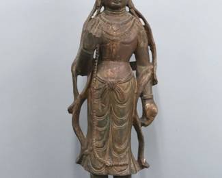 A large Chinese carved softwood figure of Guan Yin.  Depicted standing with hand raised on an incorporated base. Traces of Gilded finish, some shrinkage and minor damage.  44" high. 
