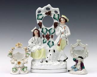Three 19th century Victorian Period porcelain pocket watch holders.  Includes a Staffordshire figural grouping and two smaller holders with figural and floral designs.  A few hairlines and minor damage overall.  Up to 12 1/4" high.  
