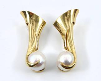 A pair of 18k Gold and Pearl Modernist drop earrings.  Feature Pearls approx. 12 mm each on scrolled drops.  Earrings unmarked, tested 18k, backs marked "14k".  19.1 grams total.  Minor surface wear, one with bent post.  Each 1 3/4" high.
