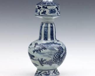 A Chinese Blue and White porcelain vase.  Modified "garlic head" form with Dragon and floral decoration.  Painted character marks, likely late Qing Dynasty c. 1910.  Minor surface wear, burst air bubbles throughout.  9 3/4" high.  
