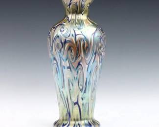 An early 20th century Quezal Art Glass vase.  Baluster form with Iridescent multi-color "King Tut" pulled decoration.  Original "Quezal" sticker at underside.  Drilled for use as lamp, minor surface wear, burst air bubble at neck.  12 1/2" high. 
