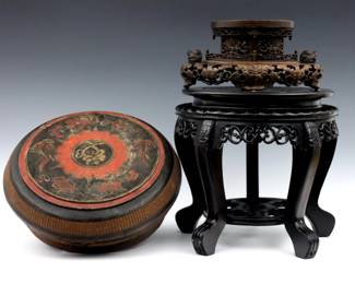 Two Chinese carved wooden stands and a wedding box.  Includes two carved hardwood stands, one with lacquered finish, and a circular wedding box with polychrome finish.  Box with painted characters at interior and underside.  Wear and minor damage, lower stands lacks portion of gallery.  Up to 13 1/2" diameter and 12" high.  
