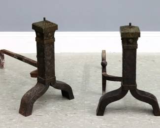 A pair of early 20th century forged Iron andirons.  Hammered finish with patinated accents.  Lacks finials, used with soot.  Each approx. 12 x 26 x 27 1/2" high overall.