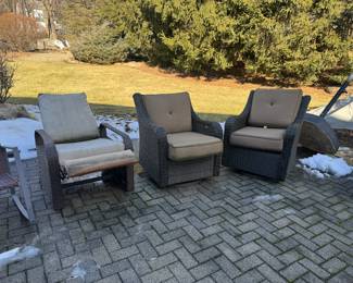 Two swivel and one reclining outdoor chairs with Sunbrella cushions