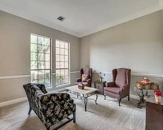 Elegant and comfortable wingback chair with vintage-style patterned upholstery and sturdy wooden legs. Perfect for a living room, office, or reading nook.