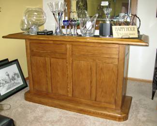 Oak bar with dry sink, black formica top, a 2 door cabinet and drawer and oak back bar, storage for stem ware, mirror back, 2 bar height stools: Sold all together $995 Please contact Diana via text or phone 708-670-2189 to arrange&nbsp;payment or with any questions.&nbsp;
