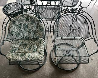 Two matching Woodard swivel patio chairs with cushions (one cushion not shown).