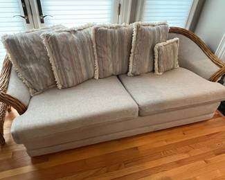 One of two matching vintage rattan couches.