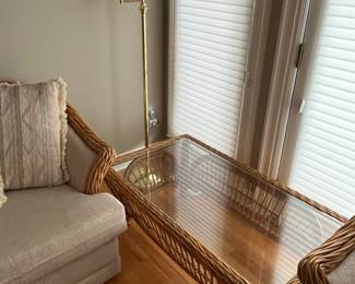 Vintage rattan coffee table; brass floor lamp.
