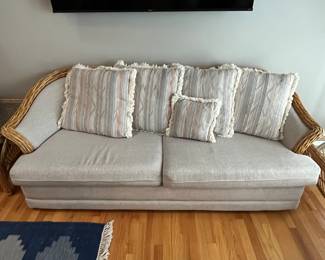 One of two matching vintage rattan couches.