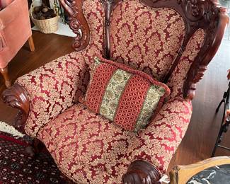 One of two matching antique wood carved chairs. Chairs match sofa shown in previous photo.