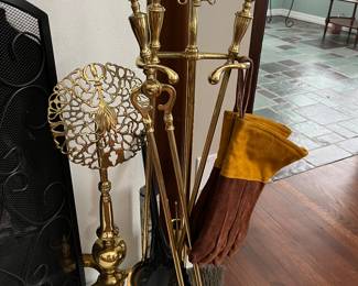 Vintage Arts and Crafts-style andirons and fireplace tools.