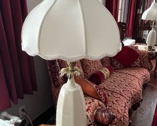 One of two matching Hollywood Regency cream ceramic and brass pineapple table lamps.