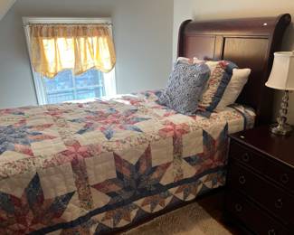 Single sleigh bed; star pattern quilt.