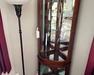 Antique-style floor lamp; corner curio cabinet.