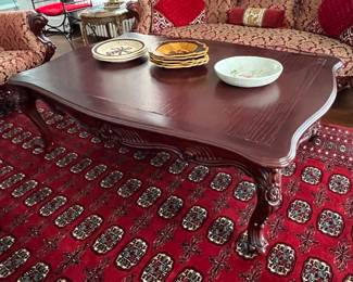 Coffee table with hand-cared/ornate sides.