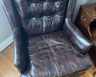 Second of two matching vintage leather armchairs.