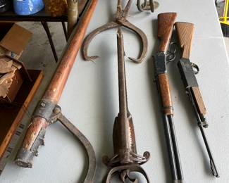 antique log roller, ice tongs, rifles