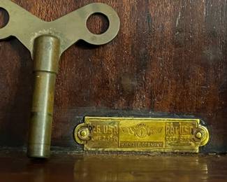 antique 1914 wall clock plaque and key