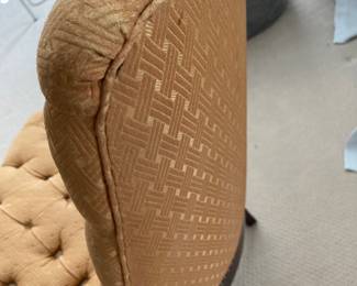 Detail of orange tufted slipper chair