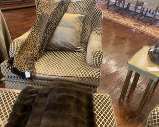 One of a pair of chairs and ottoman