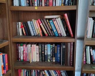 wood book shelf with books John Grisham, Vince Flynn, Tom Clancy, more