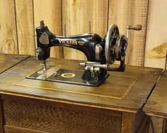 Antique English Vickers hand crank sewing machine with cabinet