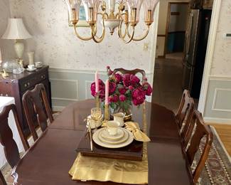 Dining table is 64" long with one, maybe two leaves each 16" wide