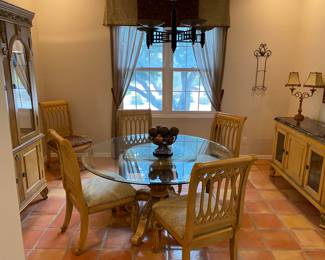Beautiful glass top round dinning room table.  It comes with 6 chairs.  Four with the same fabric, two are in different fabric