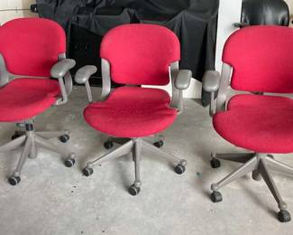 PA110Three red rolling office chairs