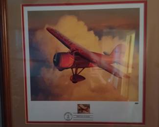 Framed vintage aircraft with commemorative Fist Day of Issue stamps.