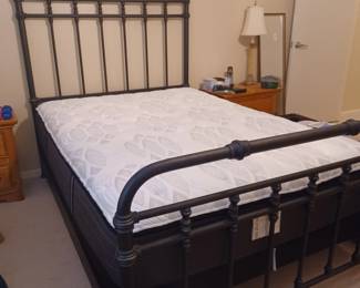 Full size black metal frame bed with Sealy mattress from Haverty's