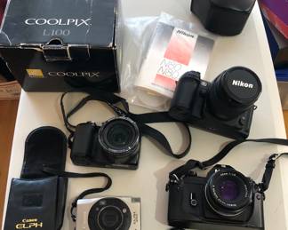 Cameras: Canon ELPH, Nikon COOLPIX L100 + box, Nikon EM with 50mm 1:1.8 lens + case, Nikon N80 with AF Nikkor 28-80mm lens