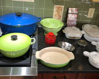 Vintage blue Le Creuset size H oval Dutch oven (with black bottom), chartreuse Le Creuset 22 soup pot, red Le Creuset butter bell, Corning Ware