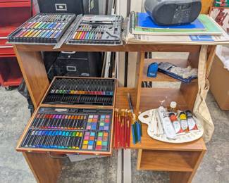 Large woodcase art supplies $30, medium plastic case art supplies $20, red set of paint brushes $10, blue set of paint brushes $5, drawing pads $2 each, oil paints $3 each, painters palette and plastic tools $10