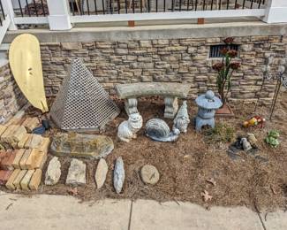 Concrete bench ($50), metal roses statue ($20), gold feather steel statue ($20), aluminum pyramid statue ($50), gnome & cat & giant snail & asian hut ($10 each), 2 frogs and 2 rabbits ($3 each), 3 tall metal yard ornaments ($3 each), large rounded rectangle stone ($10), smaller cute stones ($3 each), antique bricks ($1 each)