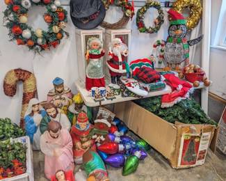 antique lighted nativity set $225, candy cane Christmas decor ($5), 40 foot jumbo rope strand of plastic Christmas bulbs ($40), antique animatronic moving lighted Mr and Mrs Claus ($150 for the pair), Christmas wreaths $10-$20, Christmas tree with built-in colored lights $70, lighted Christmas penguin $20, 4 Christmas mugs set $10, green and blue quilt $10, set of Christmas ornaments $5