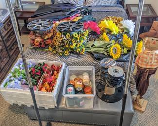 coat rack on wheels ($15), small garland strands for summer/fall/winter/spring ($5 each), large garland strands for summer/fall/winter/spring ($15 each), jar candles ($2 each), 2 large sunflower decor ($5 each), 3 large spring flowers decor ($5 each), scarecrow decor ($10)