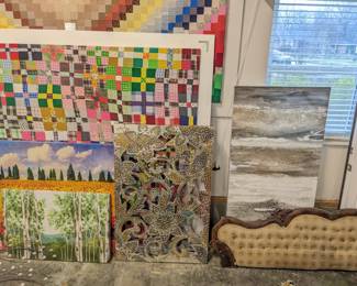 Large quilt sheets mounted onto frames $150 each, 2 trees paintings $20 and $30, glass and mirrors floral mosaic wall piece $100, gray and white tall painting $40, antique couch padded back great for bulletin board $50