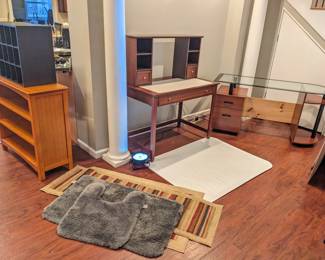 Orange bookshelf $30 stains on top, black cubbies shelf $20, two gray rugs $20, two maroon and beige rugs $20, wood desk with desktop shelves and drawer $125, glass top desk with drawers and shelves $100, chair mat for carpet $40