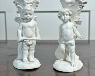 (2pc) PAIR PORCELAIN CUPID BUD VASES | Pair of porcelain bud vases with Cupid figure, each numbered on the bottom -  h. 4.5 x w. 2 x d. 2.75 in