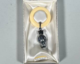 STERLING SILVER BABY RATTLE | Sterling silver bear-form baby rattle with composition ring, marked on back with English Sterling hallmarks - h. 4 x w. 2 in