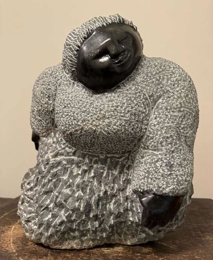 Colleen Madamombe's (1964–2009) Shona Stone Art
A very heavy Shona stone statue, measuring 13"H x 15"W.



The value of Colleen Madamombe's sculptures can vary widely depending on several factors, including the size, intricacy, condition, provenance, and whether the piece was exhibited in significant galleries or collections. Generally, her works are highly sought after due to their artistic quality and cultural significance. Here are some general pricing guidelines:



Small to Medium-Sized Sculptures: Smaller pieces or less intricate works might sell for a few thousand dollars, typically ranging from $2,000 to $10,000, depending on the details and demand.



Colleen Madamombe (1964–2009) was a celebrated Zimbabwean sculptor known for her expressive and symbolic stone carvings, which often depicted women and their roles in society. She was a prominent figure in the Shona art movement, which is centered around the traditional stone sculpting techniques of Zimbabwe.