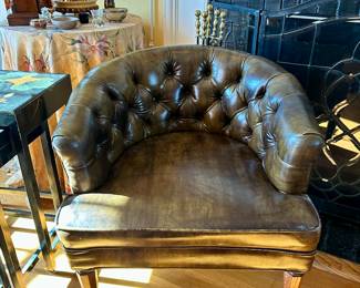 Tufted leather chair on canisters 