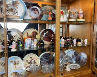Hutch filled with collectible plates and bird funnel collection 
