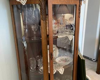Antique oak china cabinet, please note side panels are plastic, front door is glass, lots of vintage glass and china inside cabinet. This piece can be found in the formal dining room