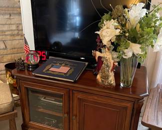 Toshiba flat screen TV, entertainment stand with lots of storage, floral in Den