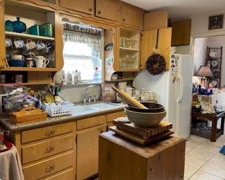 Looking into the Kitchen, crock bowls, lots of mugs and utensils