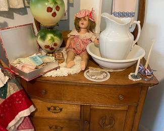 In the Guest room you will find this antique oak wash stand, just perfect. Gone with the wind lamp, composite doll and vintage linens